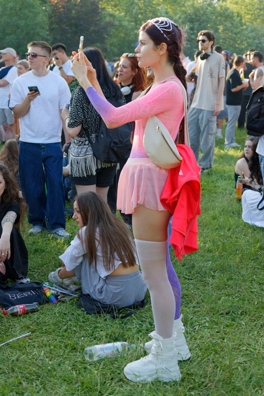 4 - Sexy person at an outdoor gathering wearing a pair of Koi Footwear chunky white boots, featuring prominent treaded soles